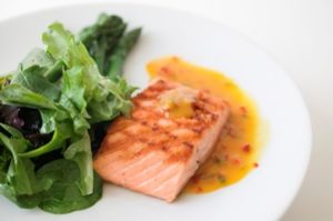 Grilled salmon on white plate