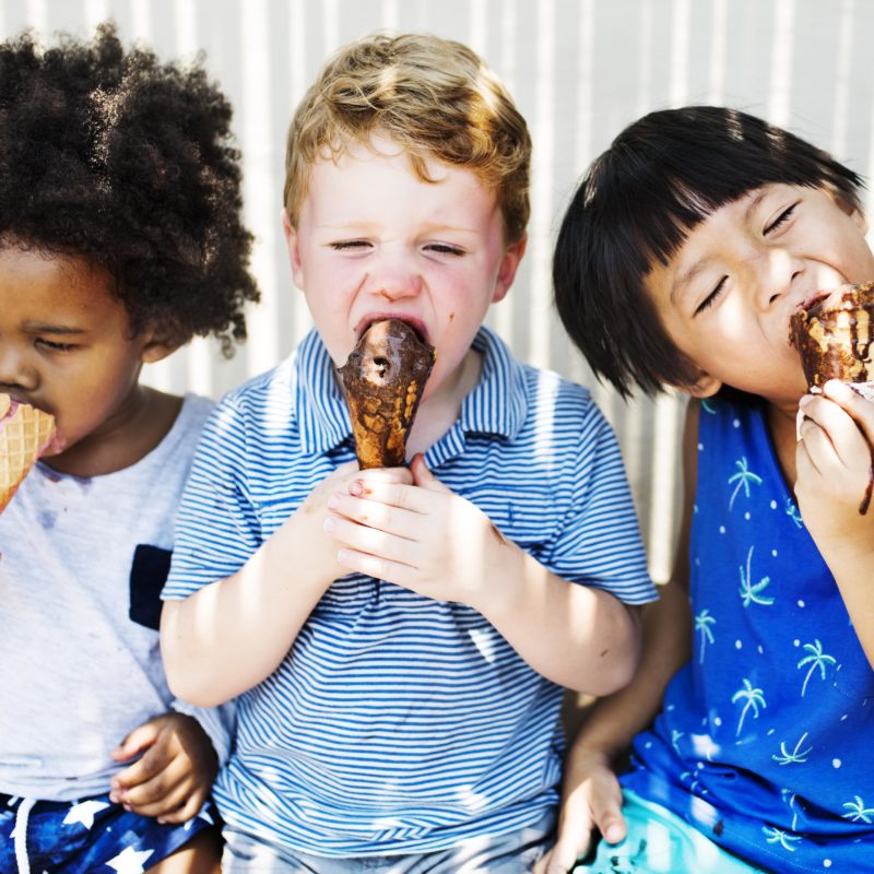 Three children enjoying ice creams