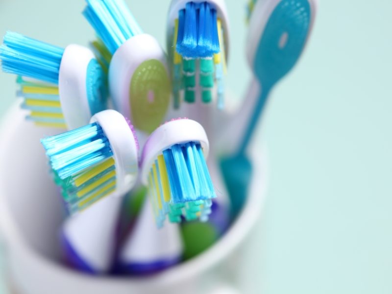 Six toothbrushes in cup
