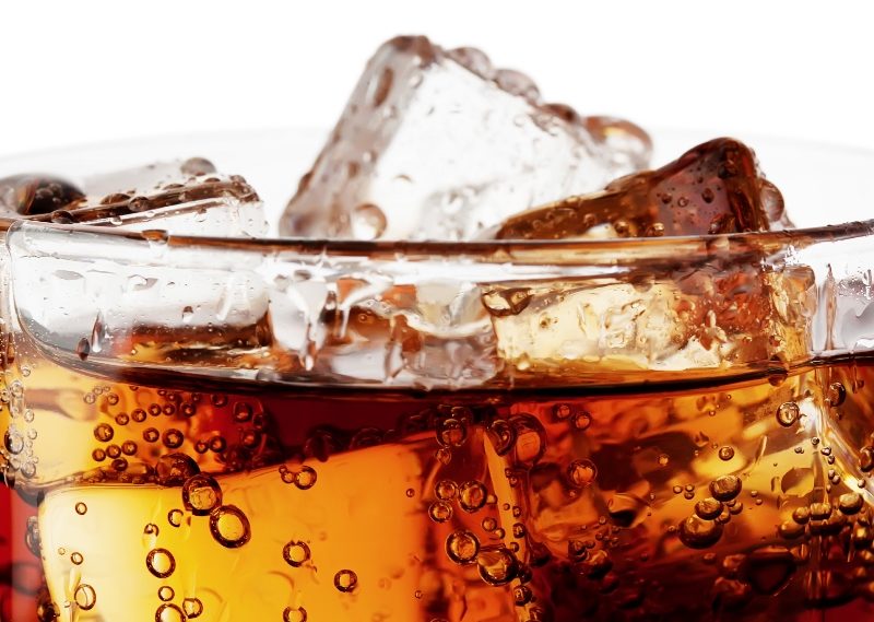 Close up of cola with ice in glass cup