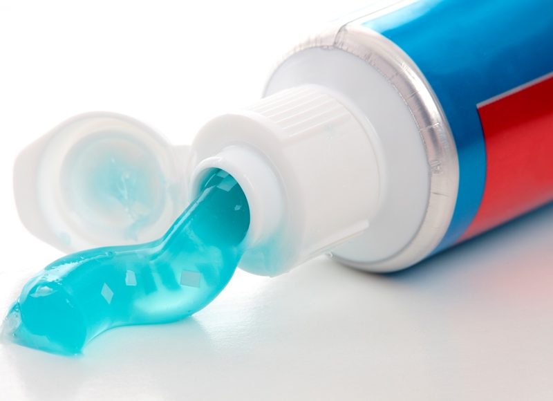 Blue gel toothpaste coming out of tube
